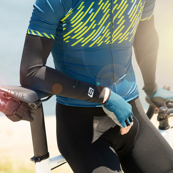 close up of cyclist wearing black sun sleeves on arms for sun protection 
