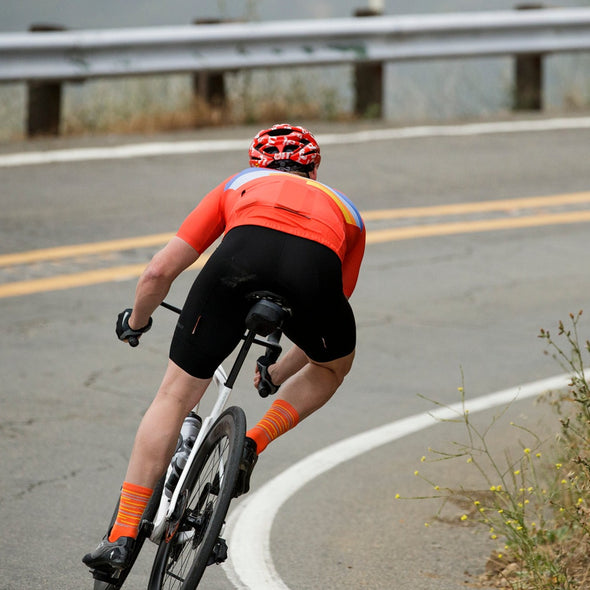 Cyclist wearing linear sock in orange color
