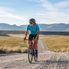 gravel cyclist on long road wearing axiom halter bib and tempo jersey 